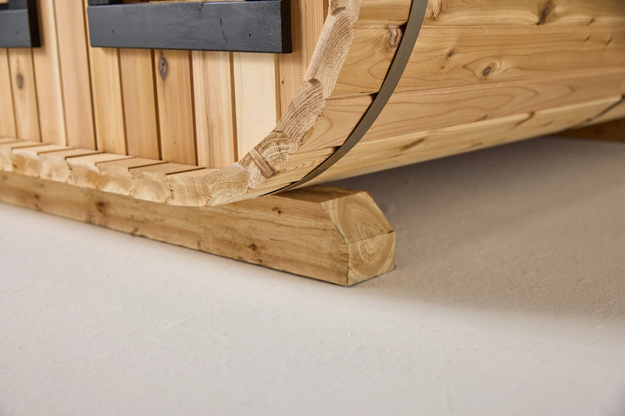 Close-up of the bottom edge of the Almost Heaven BlackWater 4 Person Cube Sauna, with curved detailing and natural wood grain, showcasing the precise joinery and craftsmanship typical of every Almost Heaven sauna.