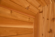 Close-up of smooth, light brown cedar planks on a curved wall, highlighting natural grain—ideal for the Almost Heaven BlackWater 4 Person Cube Sauna or any luxury outdoor sauna from Almost Heaven.