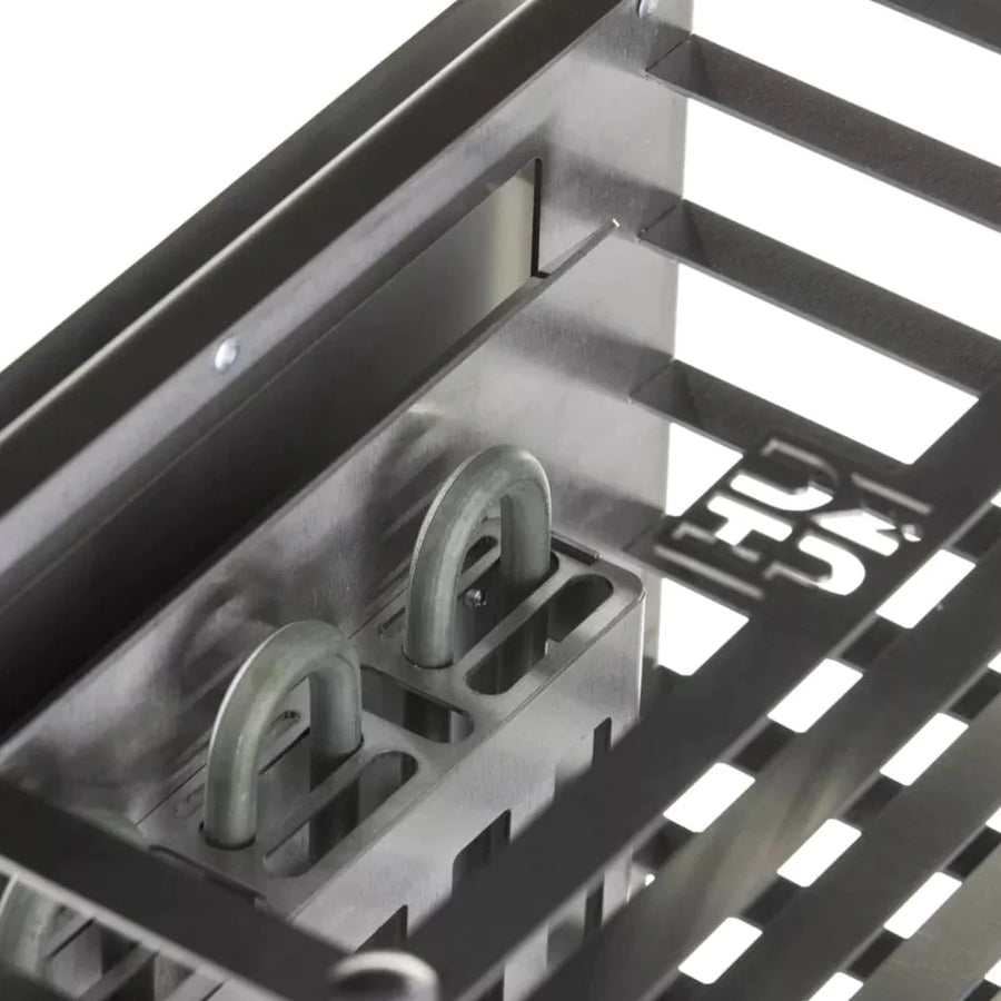Close-up of a metal rack with hooks and curved rods bearing a cut-out symbol, part of the HUUM CLIFF Mini Series 4kW Sauna Heater Package by HUUM.