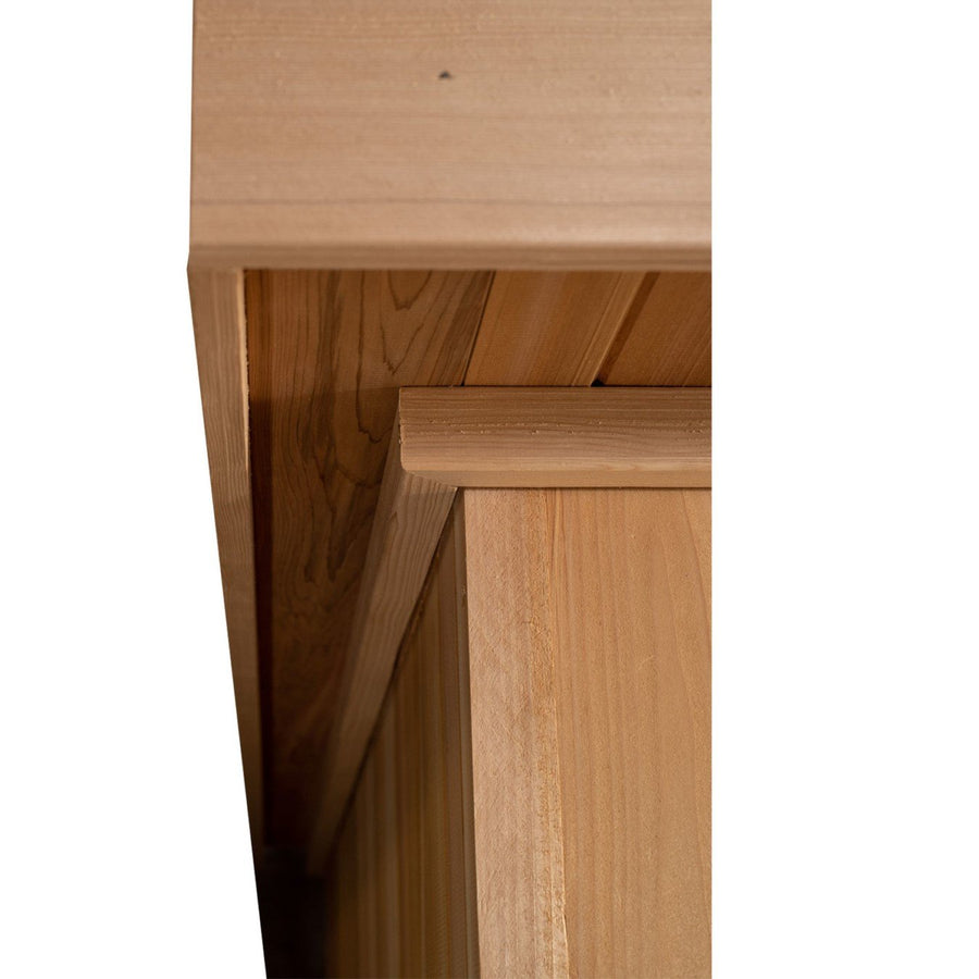 Close-up of the Almost Heaven Cascade 4 Person Indoor Sauna's wooden structure, highlighting the smooth grain at each panel intersection—ideal for relaxing indoors and compatible with a Harvia Virta heater.
