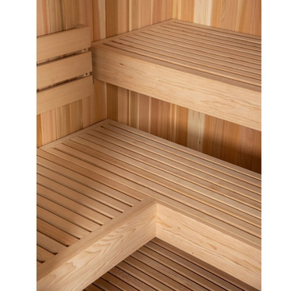 The Almost Heaven Denali 6 Person Indoor Sauna by Almost Heaven features two-tiered slatted benches and wood-paneled walls, creating a clean, inviting space for relaxation.