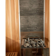 The Almost Heaven Denali 6 Person Indoor Sauna by Almost Heaven features modern stone wall panels, a metal Harvia heater with sauna stones, and wooden slats plus a corner bench for a luxurious, inviting relaxation space.