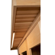 Close-up of the underside of an Almost Heaven Denali 6 Person Indoor Sauna roof overhang with a horizontal LED strip, showcasing the beautiful wood grain and detailed construction by Almost Heaven.