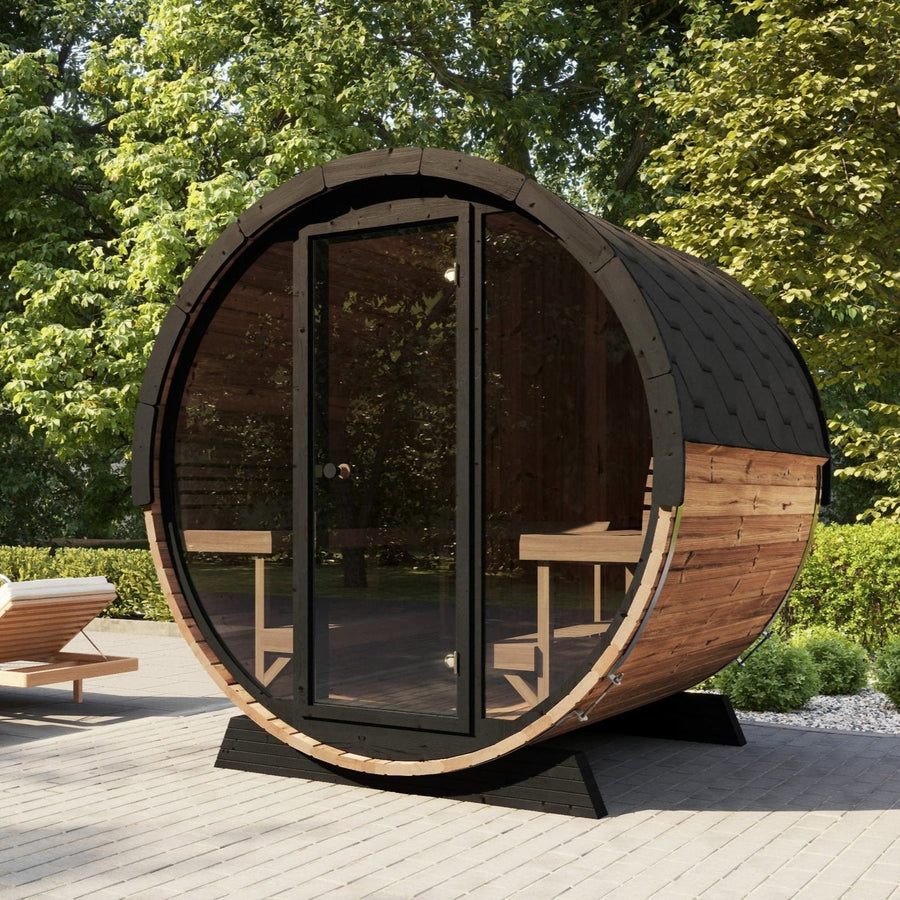 The SaunaLife Model EE8G 6 Person Barrel Sauna by SaunaLife sits on a patio with trees around it, featuring interior benches and outdoor seating—ideal for creating a relaxing backyard sauna retreat at home.