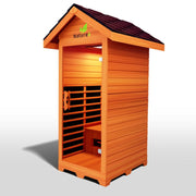 The Medical Saunas - Nature 4 Outdoor Infrared Sauna by Medical Saunas features a sloped roof, open doorway, interior bench, and slatted wooden walls with a “Nature” logo—ideal for relaxation and pain relief outdoors.