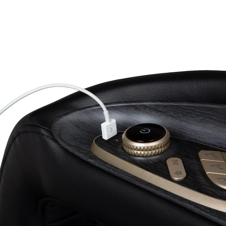 A close-up of the Osaki 4D Orion Duo Mech Massage Chair control panel shows a round power button, gold-colored buttons, and a white charging cable plugged into a USB port for a personalized massage experience.