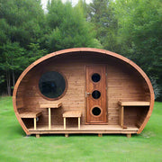 The SaunaLife Model G11 Outdoor 8 Person Sauna by SaunaLife is a compact, barrel-shaped cabin with a round window, door featuring three circular windows, and a cozy porch with benches and tables, set amidst greenery.