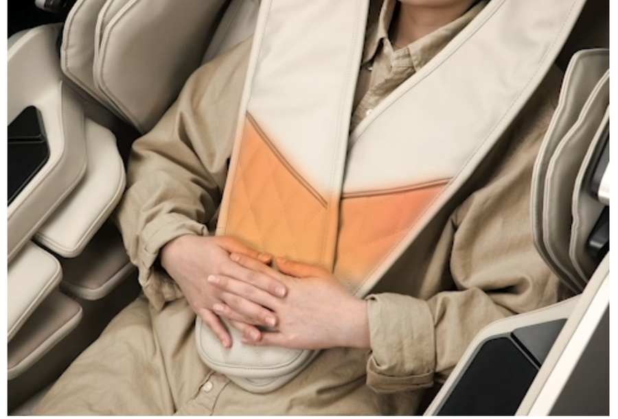 A person relaxes in an Osaki Grand Duo 4D+4D Massage Chair by Osaki, the heated massage device draped over their shoulders and chest glows orange, indicating an active heat or dual back massage function. Hands rest comfortably on their abdomen.