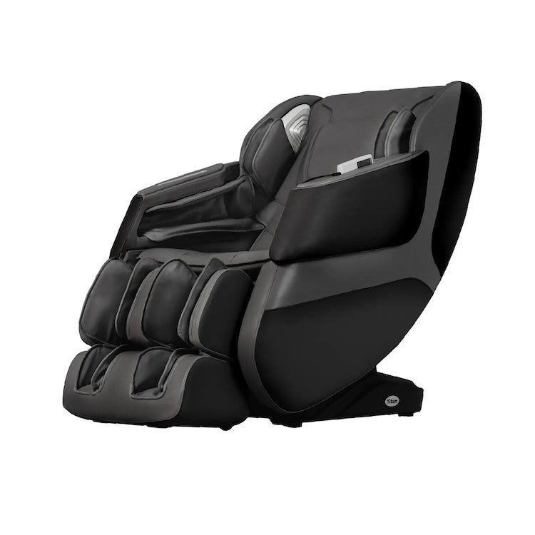 The Titan Grande XL 3D Massage Chair by Titan is a modern black chair with padded armrests, footrests, and headrest, offering full body massage, zero-gravity recline, and relaxation benefits. Shown against a plain white background.