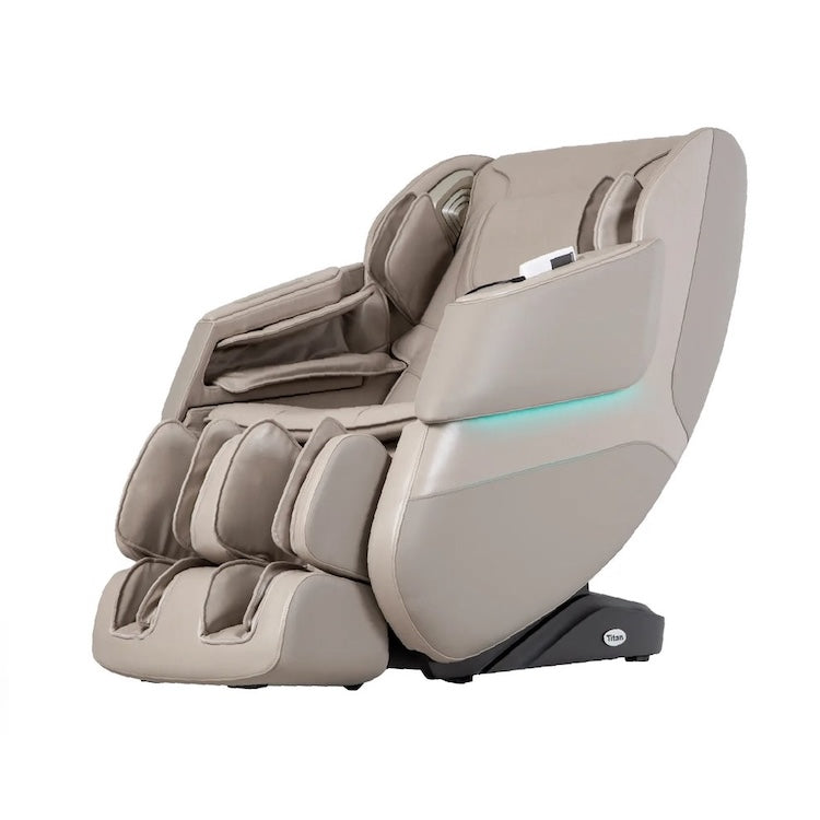 The Titan Grande XL 3D Massage Chair by Titan is a modern beige chair with padded arm, leg, and footrests, blue accent lighting, and delivers a soothing full-body massage for ultimate relaxation.