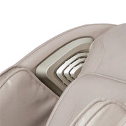 Close-up of the Titan Grande XL 3D Massage Chair by Titan, featuring sleek beige padded upholstery, a metallic side panel with concentric lines, and advanced full body massage capabilities in a modern design.