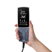 A hand holds a Titan remote with a digital display showing time, massage settings, and buttons—perfect for adjusting the Titan Grande XL 3D Massage Chair or activating zero-gravity recline during a full body massage.