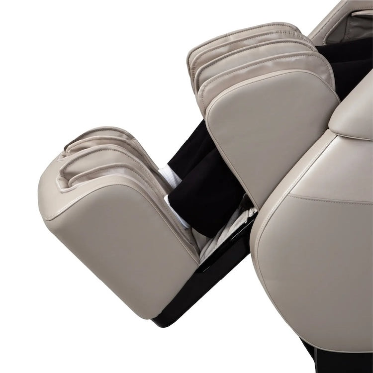 A close-up side view of the Titan Grande XL 3D Massage Chair by Titan, showing a person’s lower legs and feet in the foot and calf massage section. The chair’s ergonomic design, plush cushioning, and advanced full body massage features are visible.