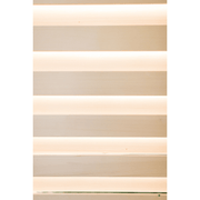 Horizontal light wooden slats with warm white light glowing between them create a modern, minimalistic striped pattern in the Almost Heaven Timberline 6 Person Cabin Sauna, evoking an inviting and relaxing ambience.