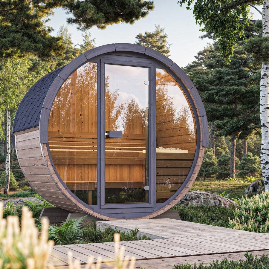 The SaunaLife Model EE8G 6 Person Barrel Sauna by SaunaLife stands on a wooden path amid lush greenery and pine trees, creating a peaceful backyard retreat. The glass door beautifully reflects the surrounding trees.