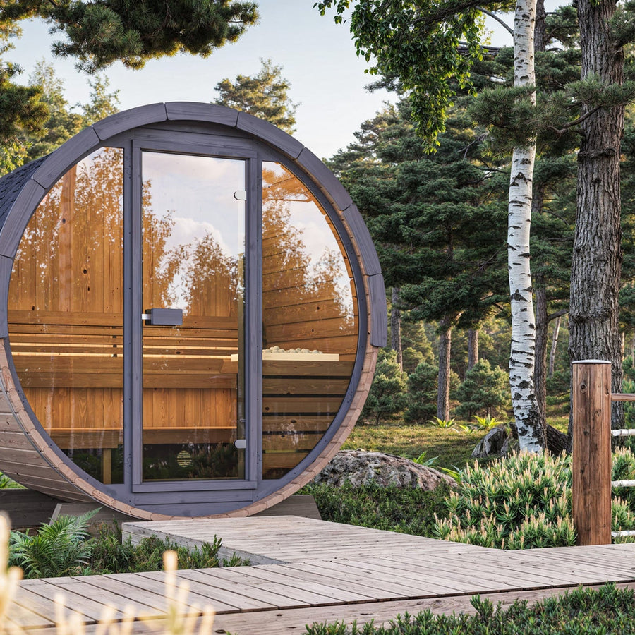 The SaunaLife Model EE6G 4 Person Barrel Sauna by SaunaLife features a round, modern design with a glass door, set on a wooden path amid lush greenery and tall forest trees.