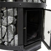A close-up of a black Harvia Legend 240 GreenFlame Sauna Stove by Harvia shows its side door open, revealing the firebox. Gray stones are stacked vertically behind metal bars along the stove’s edge.