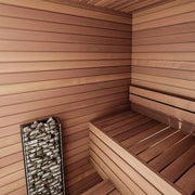 A modern wooden sauna interior features smooth horizontal panels, a wooden bench, and a sleek HUUM CLIFF Mini Series 4kW Sauna Heater Package by HUUM filled with stones in the corner.