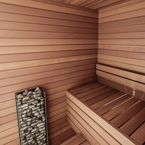 A modern wooden sauna interior features smooth horizontal panels, a wooden bench, and a sleek HUUM CLIFF Mini Series 4kW Sauna Heater Package by HUUM filled with stones in the corner.