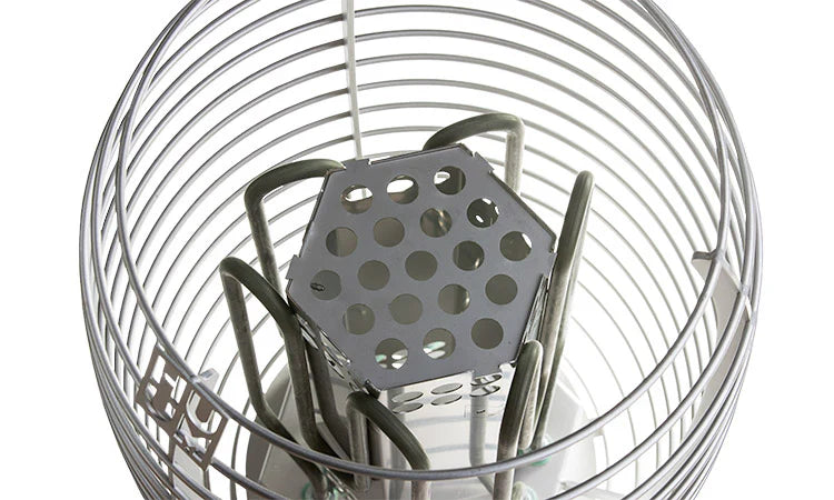 A close-up of the HUUM HIVE Series 15.0kW Sauna Heater Package by HUUM, showing its metal immersion heater with a protective wire cage around the coiled element and a perforated center plate.