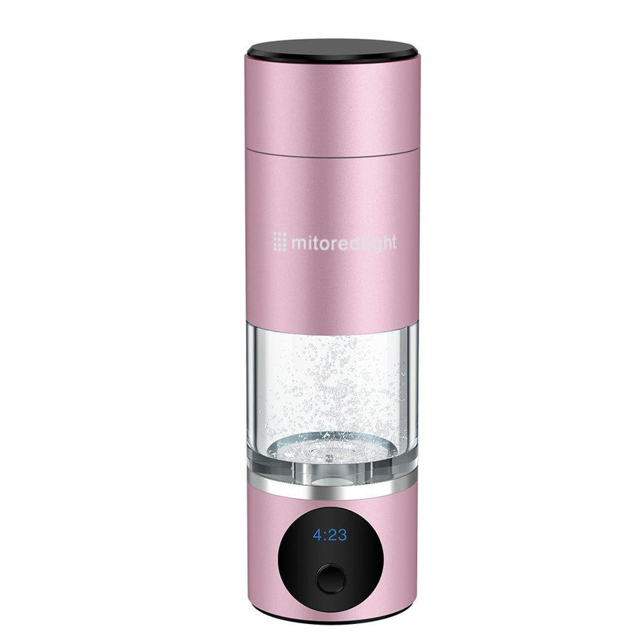 The MitoHYDRO™ Ultra Premium Hydrogen Water Bottle by Mito Red Light is a pink, portable bottle with a digital display showing 4:23, a transparent middle section with bubbles forming antioxidant-rich hydrogen water, and the brand name printed on top.