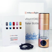 A MitoHYDRO™ Ultra Premium Hydrogen Water Bottle by Mito Red Light in rose gold is shown with its box, a user manual displaying color choices, and a black charging cable. Enjoy antioxidant-rich hydrogen water with this advanced design.