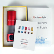 A red MitoHYDRO™ Ultra Premium Hydrogen Water Bottle by Mito Red Light, its user manual, and the product box are displayed. The manual features this antioxidant-rich bottle in black, white, red, pink, and gold.
