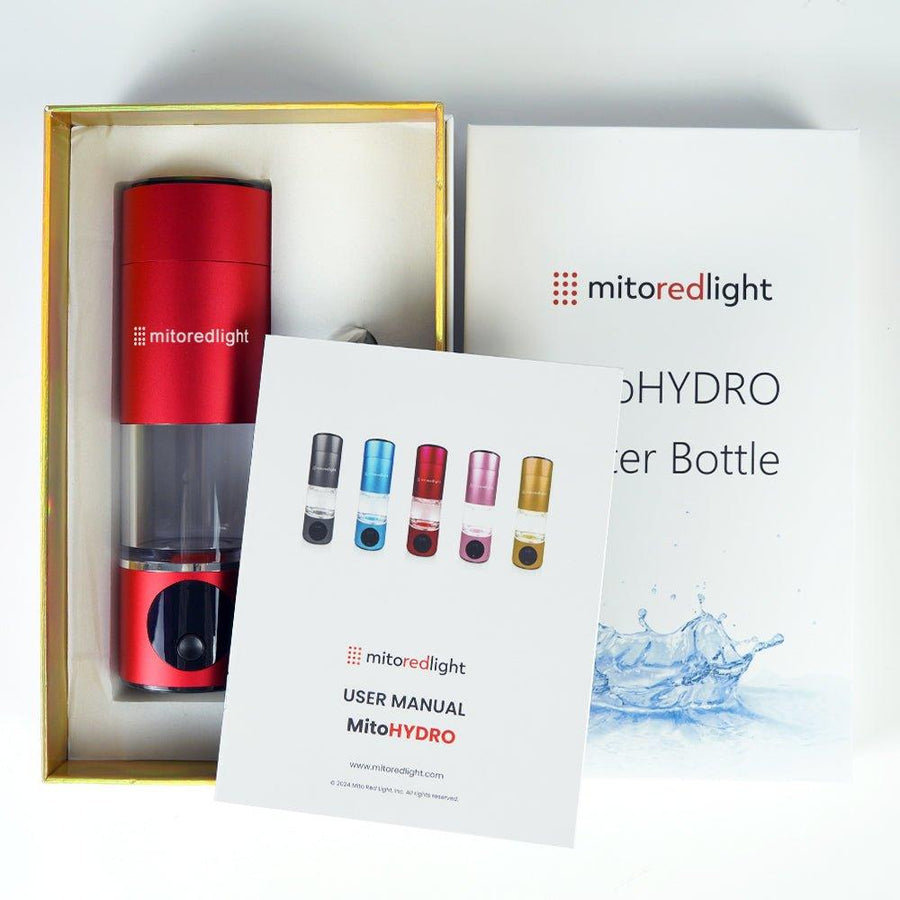 A red MitoHYDRO™ Ultra Premium Hydrogen Water Bottle by Mito Red Light, its user manual, and the product box are displayed. The manual features this antioxidant-rich bottle in black, white, red, pink, and gold.
