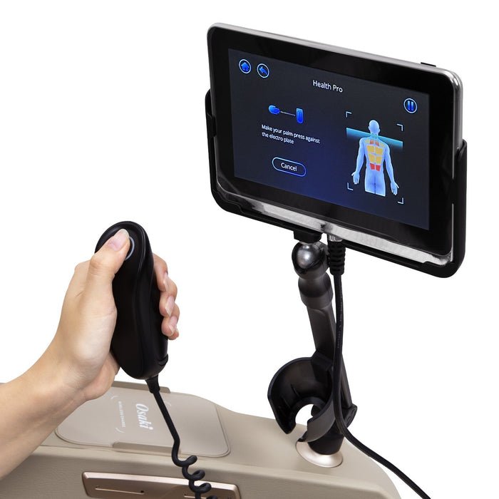 A hand holding the Osaki 4D Maestro LE 2.0 Massage Chair's touchscreen controller, highlighting advanced features like voice control and zero gravity reclining.