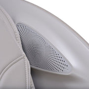 Close-up of a gray perforated speaker embedded in the armrest of the Osaki 4D Manhattan Duo Mech massage chair by Osaki, featuring light gray leather and advanced AI massage technology designed for superior comfort.