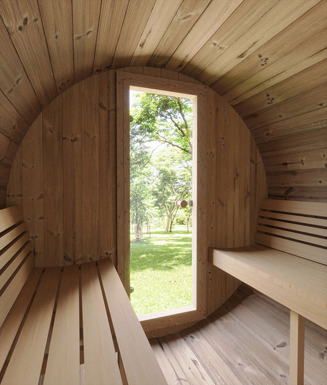 Interior of the SaunaLife 4-Person E7 ERGO Series Barrel Sauna with benches on both sides and a tall window at the end, framing a view of green grass and trees—showcasing SaunaLife comfort and design.