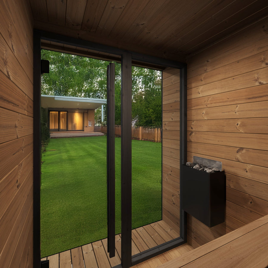 Experience the SaunaLife Model GL4 4 Person Garden Luxury Series Outdoor Sauna Kit, featuring Scandinavian design with a glass door overlooking a green lawn, modern home, trees, and wooden fence.