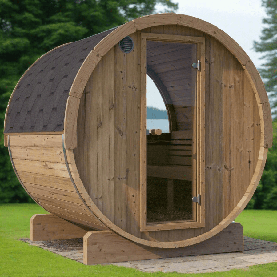 The SaunaLife Model E7W 4 Person Sauna Barrel-Window by SaunaLife is a round, ergonomic outdoor sauna with a curved roof and glass door, set on a stone base in a grassy area surrounded by trees.