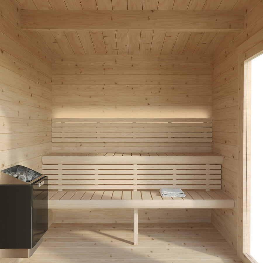 The SaunaLife G4 6-Person Outdoor Cabin Sauna by SaunaLife features two bench levels, a left-side heater with stones, and a folded newspaper on the lower bench. Sunlight streams through the right window for an inviting outdoor sauna experience.
