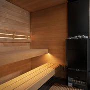The SaunaLife G6 5-Person Outdoor Cabin Sauna features smooth wood paneling, wooden bench seating, warm ambient lighting, and a black electric sauna heater with sauna stones in the corner—a modern luxury from SaunaLife.