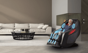 An older man relaxes in a Daiwa Hubble Massage Chair by Daiwa, featuring glowing blue massage points and advanced airbag massage, in a modern living room with a white sofa, round coffee table, and built-in fireplace.