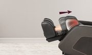 A person relaxes in a Daiwa Hubble Massage Chair by Daiwa with their legs elevated; a red highlight and arrow show the airbag massage function at work on the lower leg area.
