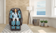 A woman relaxes in a Daiwa Majesty Massage Chair by Daiwa as blue graphics highlight its 3D body scan technology targeting arms, legs, and back. Sunlight streams through large windows with indoor plants for a calming ambiance.