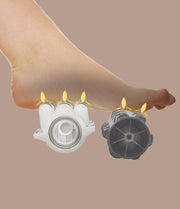 A bare foot hovers above two spiked massage rollers with small flames, capturing the soothing relief of the Daiwa Majesty Massage Chair by Daiwa, set against a plain brown background.