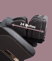 A person sits in a Daiwa Pegasus 2 Smart Massage Chair by Daiwa with extended calf supports. An arrow marks the calf section's 24-inch width, set against a plain mauve background.