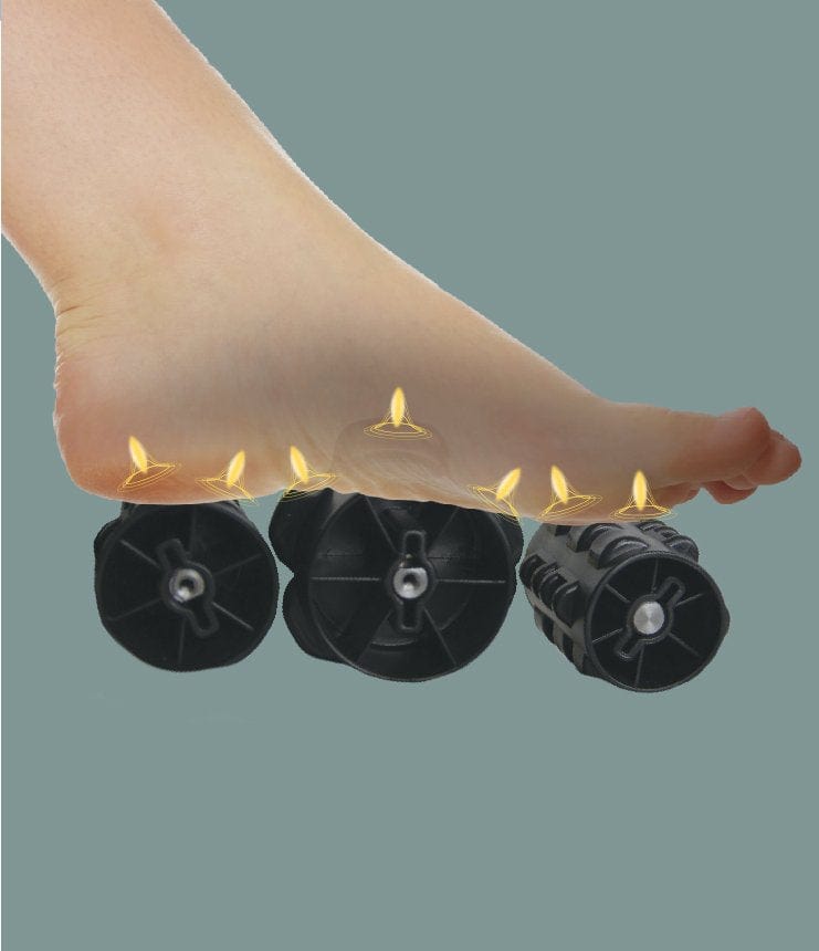 A bare foot rests on three black foam rollers with yellow glowing points, evoking the stress-relieving, acupressure-like effects of the Daiwa Relax 2 Zero 3D Massage Chair by Daiwa—like full-body massage therapy for your feet.