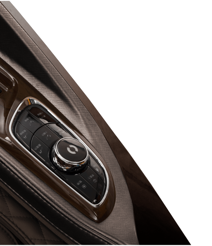 Close-up of the Daiwa Supreme Hybrid Massage Chair’s center console, featuring a glossy rotary dial with control buttons, set in brown wood or metallic trim with quilted leather upholstery, echoing the brand's signature blend of luxury and comfort.