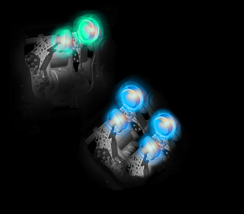 A semi-transparent engine shows two green and two blue pistons in motion, illustrating targeted relief—just like the Daiwa Supreme Hybrid Massage Chair’s L-shaped track—while a dark background highlights the details.