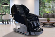 The Kyota Yosei M868 4D Massage Chair by Kyota is placed in a modern living room with a gray sofa, round coffee table, and large windows revealing green trees, offering relaxing foot massage and soothing lumbar heat.