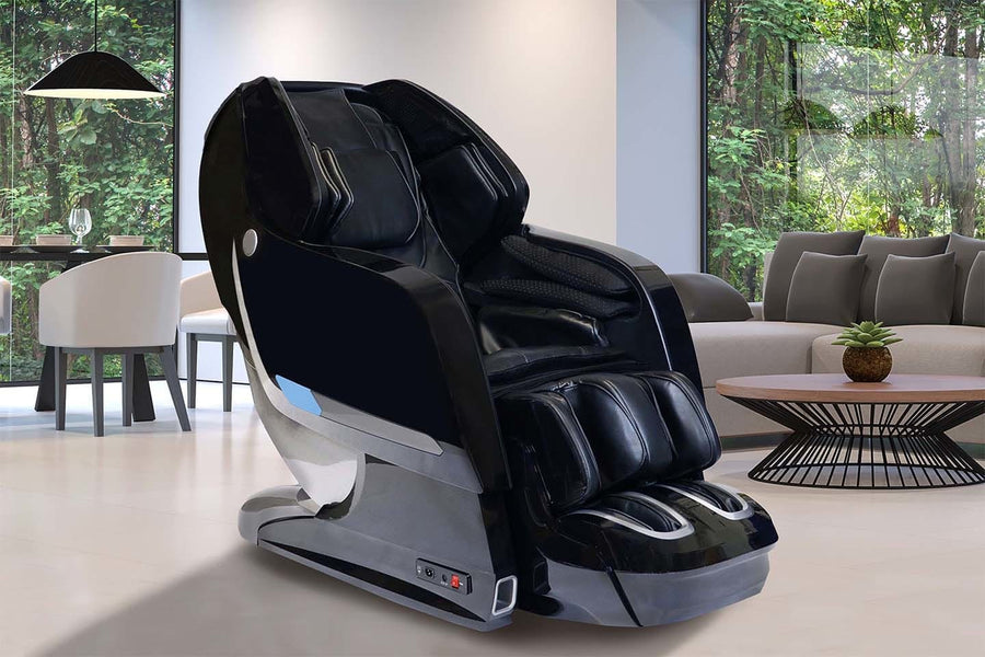 A Kyota Yosei M868 4D Massage Chair by Kyota sits in a modern living room with large windows and green views, near a brown coffee table and gray sofa—ideal for enjoying relaxing foot massages at home.