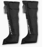Two black Recovery Wraps™ Wireless Compression Boots by Icebound Essentials, each with foot coverings and a control unit on the upper outer side, are displayed side by side against a white background.