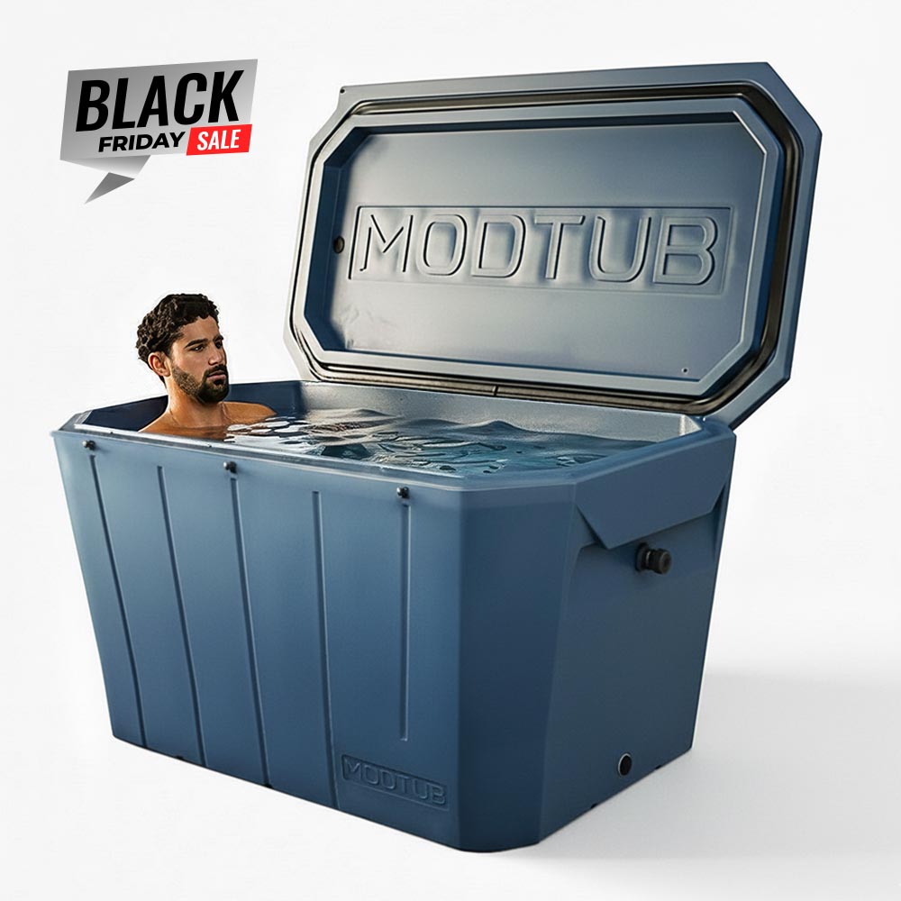 A man relaxes in a large blue Modtub 2.0 Cold Plunge (Tub Only) by Modtub, made in the USA, with its lid open. A Black Friday Sale sign appears in the top left corner on a plain white background.