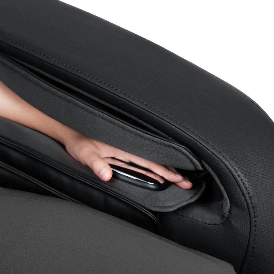 A hand reaches into the side pocket of an Osaki 4D YogaFlex Massage Chair to retrieve a TV remote control.