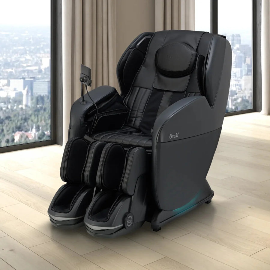 The Osaki 4D YogaFlex Massage Chair by Osaki, in sleek black with foot and arm rests and an SL-Track 4D mechanism, sits on a light wood floor in a bright room with large windows overlooking the city.