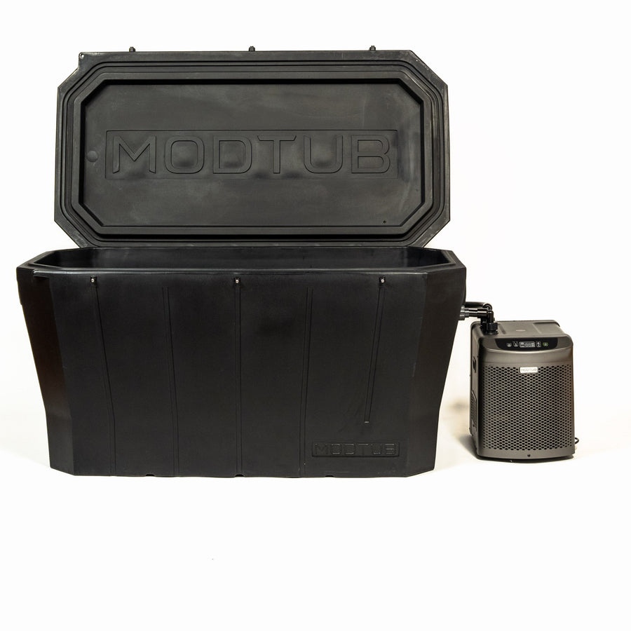 A large black rectangular tub labeled Modtub 2.0 - Cold Plunge System by Modtub, designed for cold therapy, with an open lid sits beside a compact metal device featuring a vent and control panel, all set against a white background.